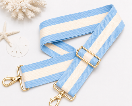 Strapistry Coastal Sky Strap product spec sheet showing the 2 inch wide woven polyester webbing, adjustable 24-50 inch length, gold-tone hardware, and colorway swatches for crossbody, shoulder, and backpack carry