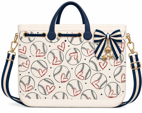 Game Day Baseball Tote in cream with a baseball and heart pattern print, navy handles, and a navy striped crossbody strap with a nautical charm bow